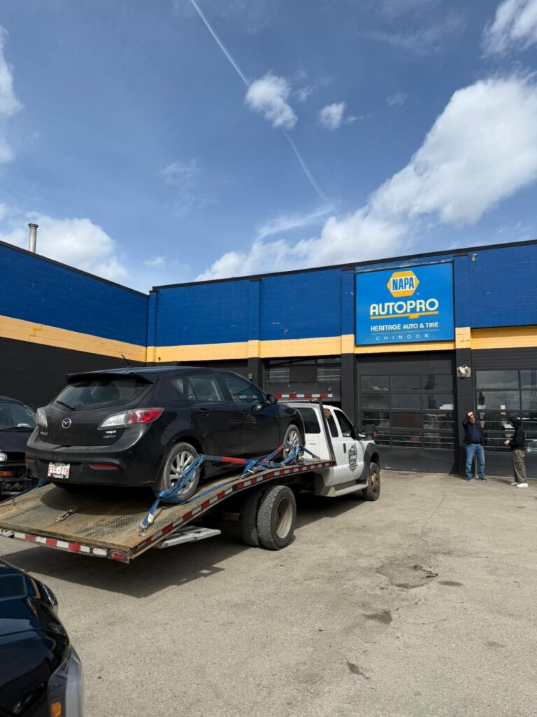 Jim Towing delivering a vehicle to an auto repair shop in Calgary