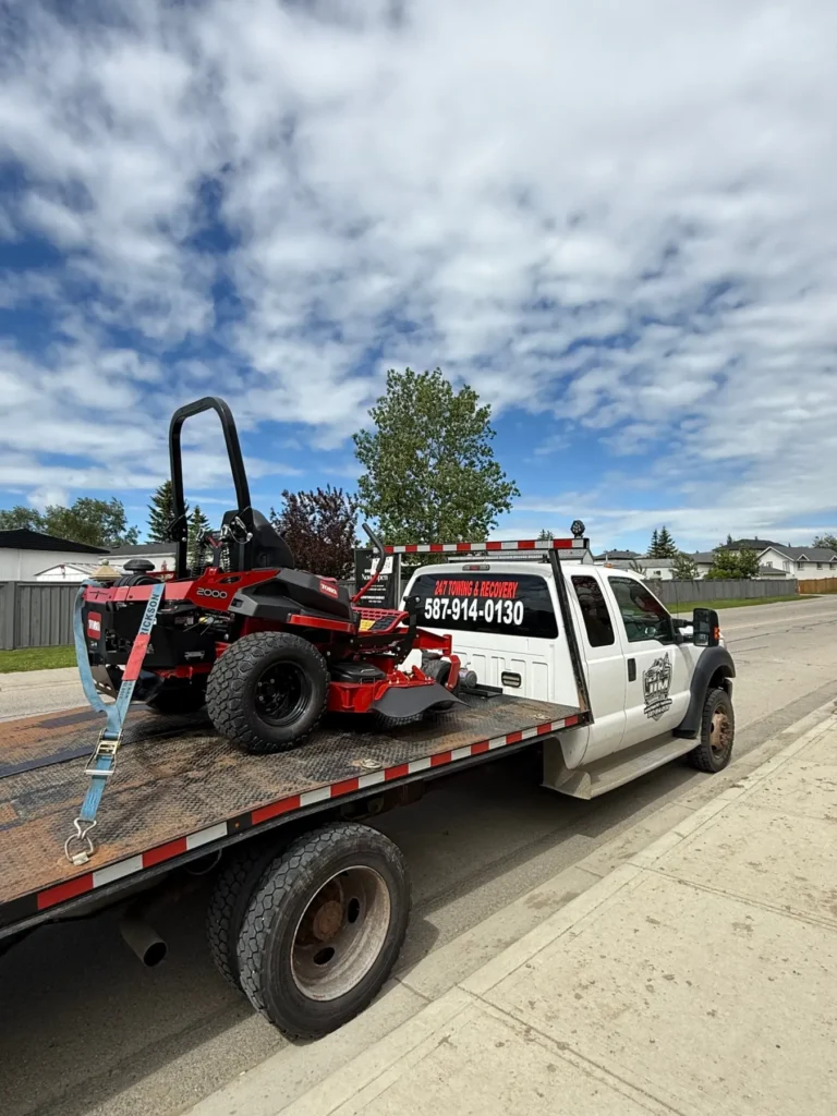 Small equipment strapped to a Jim Towing flatbed