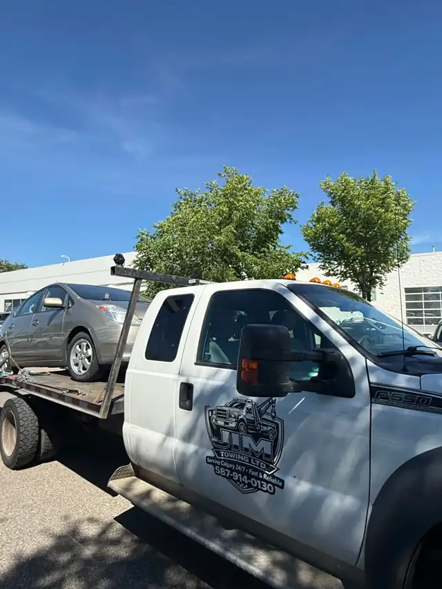 Jim Towing Ltd. tow truck with company logo