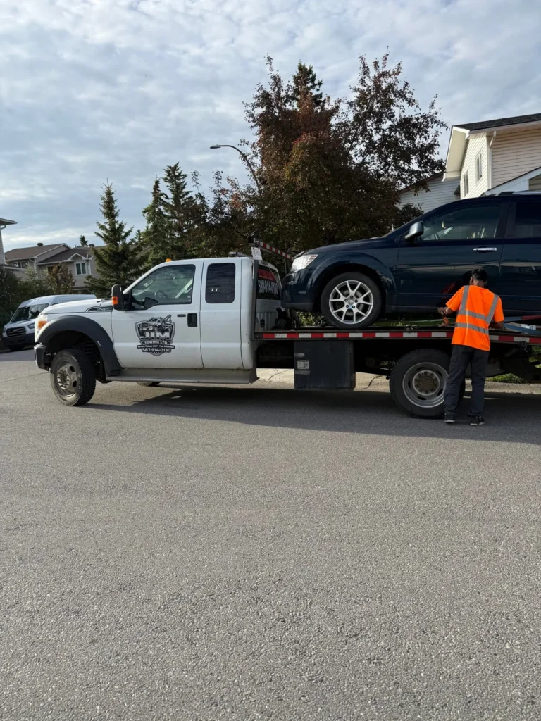 Jim Towing operator securing an SUV on the flatbed